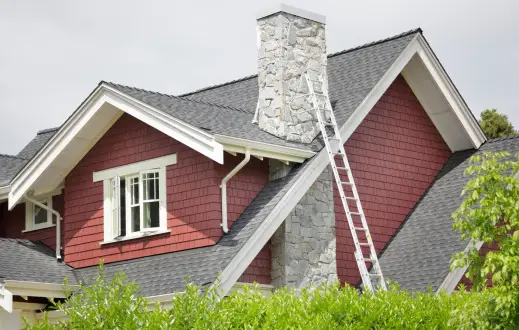 A ladder leaning up against the side of a house.